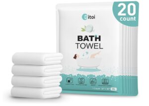 A package of Ditoi disposable bath towels next to a stack of four folded white towels.